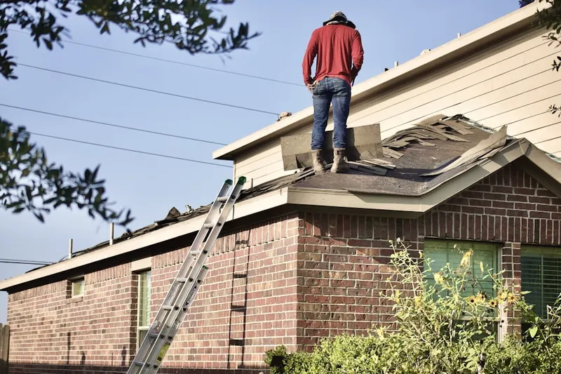 Professional roofer working on a residential roof in Mahoneyville